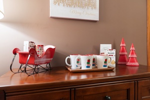 Hot cocoa station adorned with holiday mugs and candy canes, ready to spread holiday warmth.