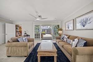 Relax in style at this Hawaii vacation rental, featuring luxurious couches and a breezy, open-concept design.