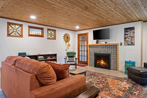 Catch up on your favorite shows or sip tea by the fire in a living room designed for connection and calm.