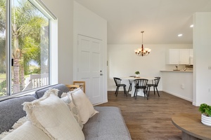 Sink into plush cushions while natural light floods your open living space, creating the perfect backdrop for memorable meals and relaxation.