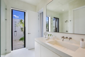 Freshen up in the bright bathroom with easy access to the outdoor shower.