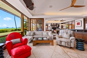 Bright family lounge with pool and garden views.