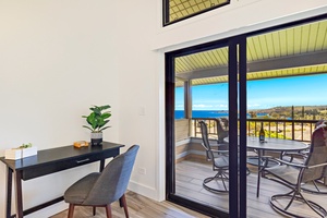 A cozy workspace near the lanai offers an inspiring view, perfect for catching up on work while enjoying the breathtaking ocean backdrop.