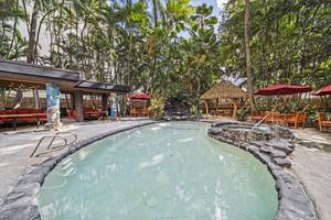 Relax in the tropical shared pool surrounded by lush palms—perfect for a refreshing afternoon escape.