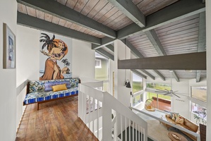 Lofted hallway with island artwork, offering a unique blend of comfort and Hawaiian culture.