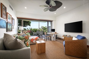 Seamless indoor-outdoor living in the family den with a sliding glass pocket door that leads to the lanai.