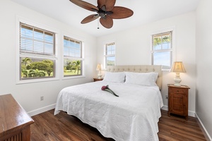 Upstairs guest bedroom with a king-sized bed, AC, and TV.