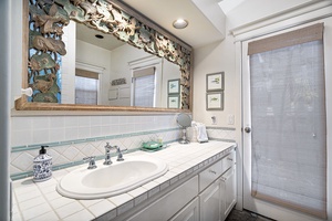 Ensuite bathroom features dual sinks and access to the outdoor shower.