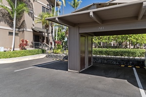 Covered parking space 701 provides convenient protection for your vehicle in this tropical Hawaiian setting with lush palm trees and landscaping.