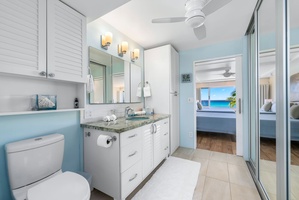 Bright spa-style bathroom with ample vanity space and natural light—perfect for refreshing between beach days and sunset dinners.