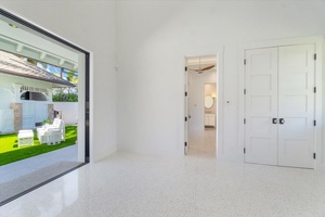 Spacious flex room with courtyard views and versatile potential for guests or work.