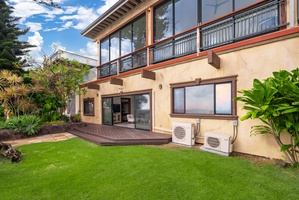 Rear exterior view showcasing the beautiful landscaped garden and patio.