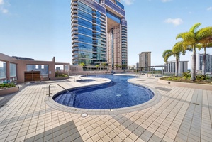 Swim beneath Honolulu’s skyline in the resort-style rooftop pool and spa area.