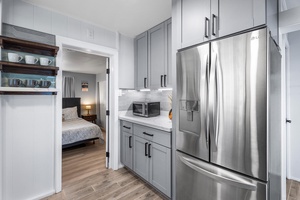 Modern stainless-steel fridge and ample kitchen space for home-cooked meals.