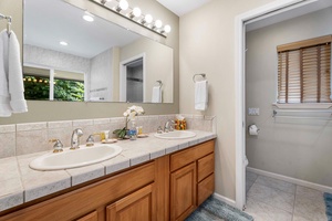 Spacious primary bathroom with dual vanities.