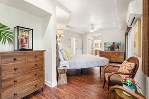 Drift into tropical dreams in your serene bedroom, where warm wood floors and island-inspired décor create the perfect retreat.