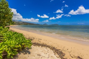 Kahala Beach with blue skies and Pacific views.