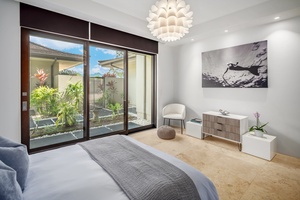 Serene bedroom with large sliding doors opening to lush garden views, creating a peaceful ambiance.