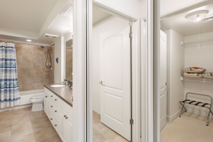 Your spacious bathroom features a relaxing tub-shower combo, generous vanity storage, and thoughtful touches like fresh towels and luggage rack.