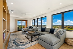 Sink into plush sectional seating in your media room while panoramic windows frame stunning views beyond your modern retreat.