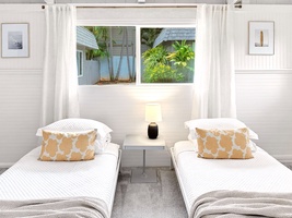 Rest peacefully in your bright twin bedroom with tropical garden views and crisp white linens.