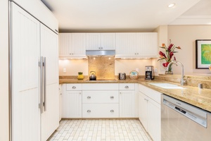 A second view of the kitchen shows the bright layout, ideal for family cooking and entertaining.