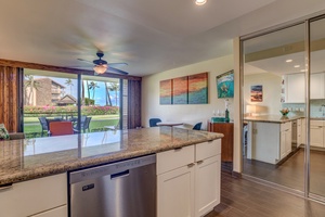 Enjoy meal prep at Papakea B-105’s spacious kitchen island with garden views from the lanai.