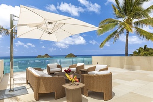 Upper lanai deck with plush seating and breathtaking views of the Mokulua Islands.