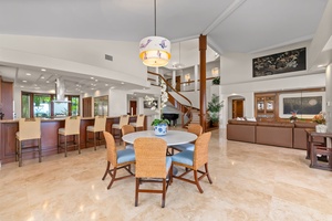 Gather beneath soaring ceilings where open living spaces flow effortlessly from dining to lounge areas.