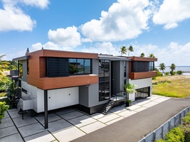 A dramatic steel, glass, and wood façade sets the tone for luxury living in this Honolulu estate.