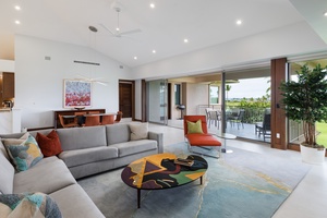 Relax in the stylish living area featuring plush sectional sofas and direct access to the lanai.