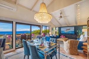 Dine in style at Wailea Ekolu 1106 with bold blue accents and views through floor-to-ceiling windows.