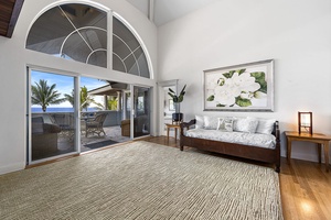 Expansive vaulted ceilings and arched windows fill the primary suite with natural light.