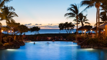 Relax in the community pool during twilight.