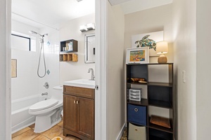 Step into your thoughtfully designed bathroom featuring a relaxing tub-shower combo and warm wood vanity that makes your daily routine feel like a spa retreat.