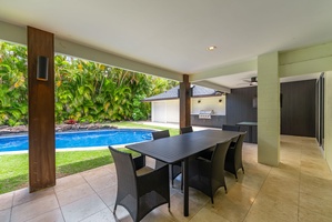 Covered lanai with outdoor dining, perfect for family meals fresh off the grill.