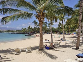 Relax at the exclusive Mauna Lani Beach Club with sandy shores and calm waters.