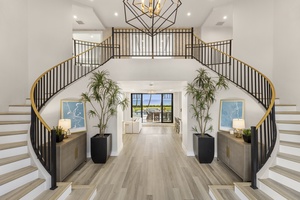 Grand double-staircase foyer that sets a dramatic tone as soon as you step inside.