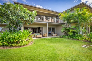 View from private grassy lawn area toward the back of this lovely and spacious home.