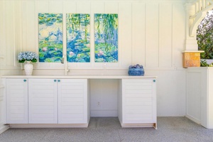 Artful built-in cabinetry adds a decorative touch and convenient storage near the lanai.