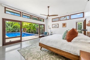 Primary bedroom with walk in closet and ensuite and pool views!