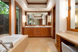 The en suite bathroom offers dual sinks & a distinct makeup vanity