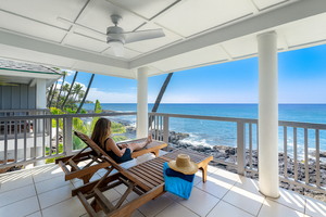 Upper-level private lanai with lounge chairs overlooking the breathtaking Kona coastline.