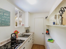 The spacious kitchen with an attached laundry room for added convenience.