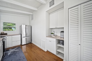 Additional kitchen angle showcasing upgraded appliances and organized storage for a seamless vacation cooking experience.