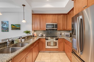 Spacious fully stocked kitchen area.