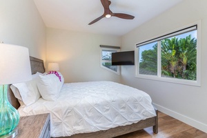 The upstairs third guest bedroom has flat-screen TV and garden views.