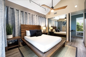 Sleep peacefully in this modern sanctuary with rich wood furnishings, ceiling fan, and private balcony access.