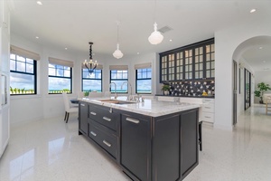 Central island anchors the kitchen with seating and storage, perfect for entertaining.