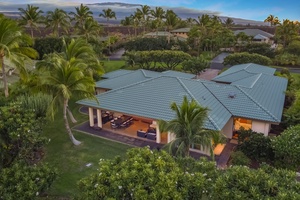 Aerial view of the immaculate property, showcasing the main lanai surrounded by lush tropical greenery and privacy.